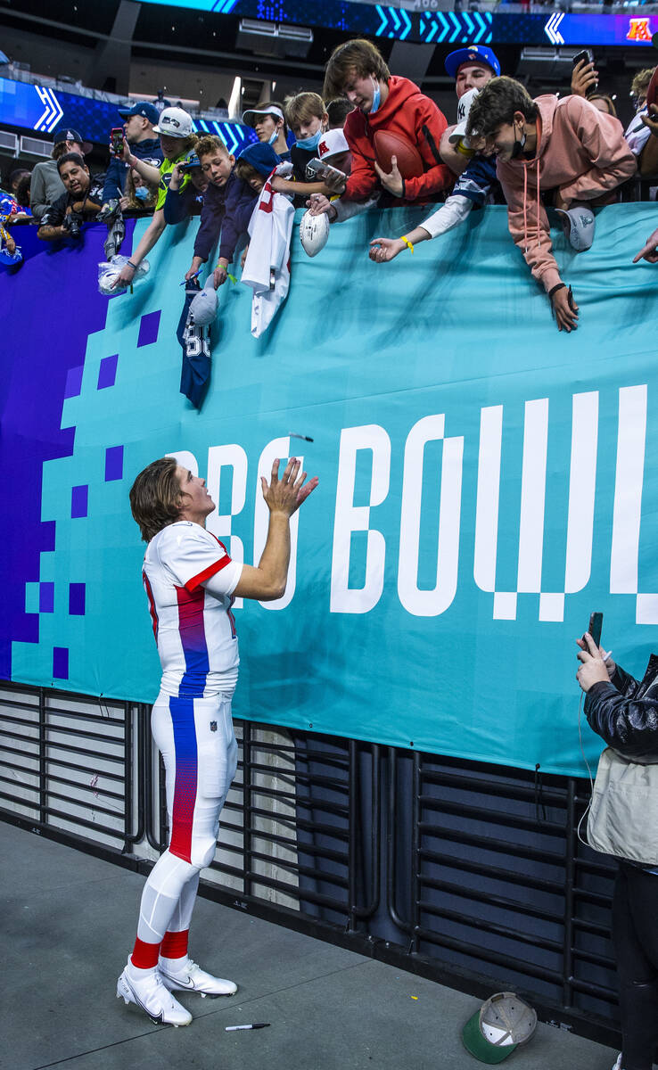 AFC quarterback Justin Herbert of the Los Angeles Chargers catches a sharpie while signing auto ...