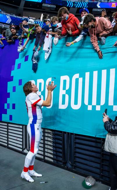 AFC quarterback Justin Herbert of the Los Angeles Chargers catches a sharpie while signing auto ...