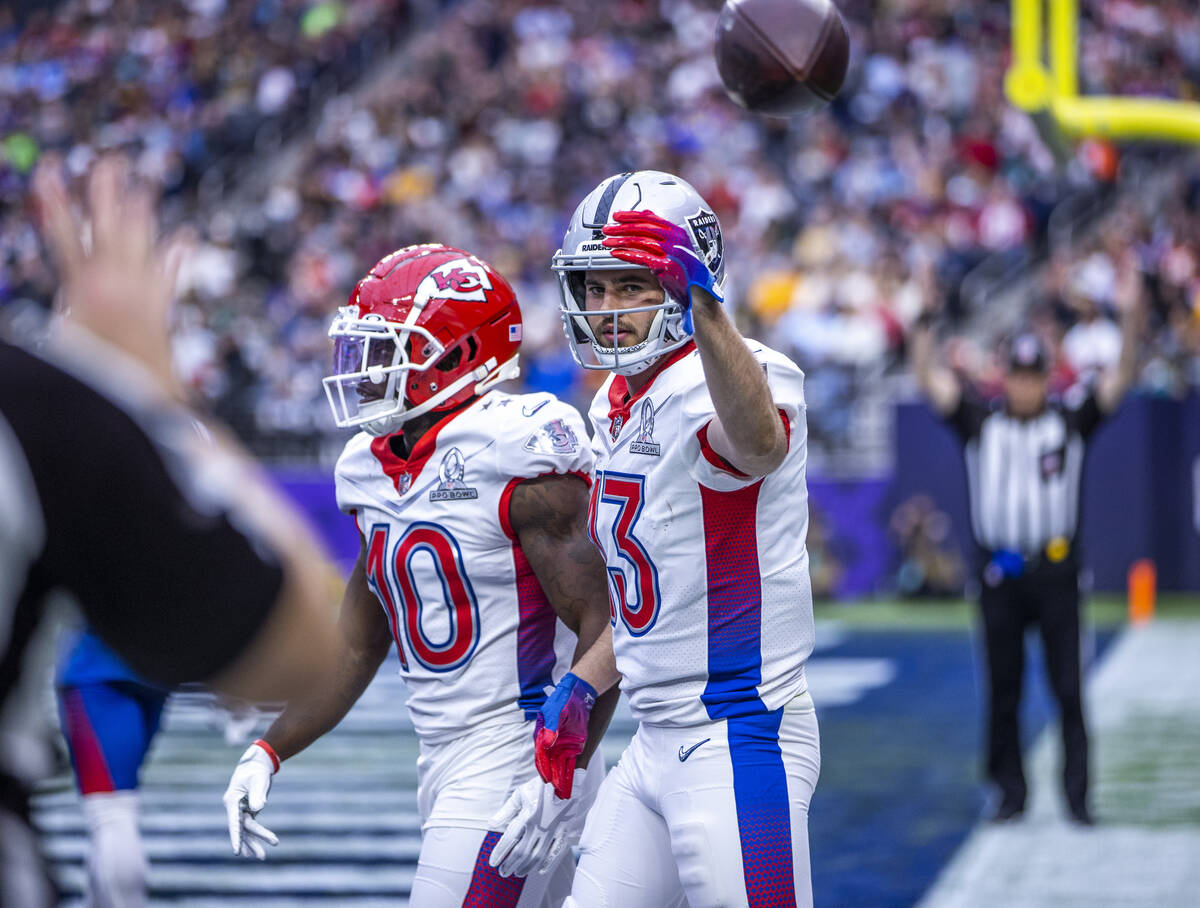 AFC wide receiver Hunter Renfrow of the Las Vegas Raiders (13) tosses a ball back after scoring ...