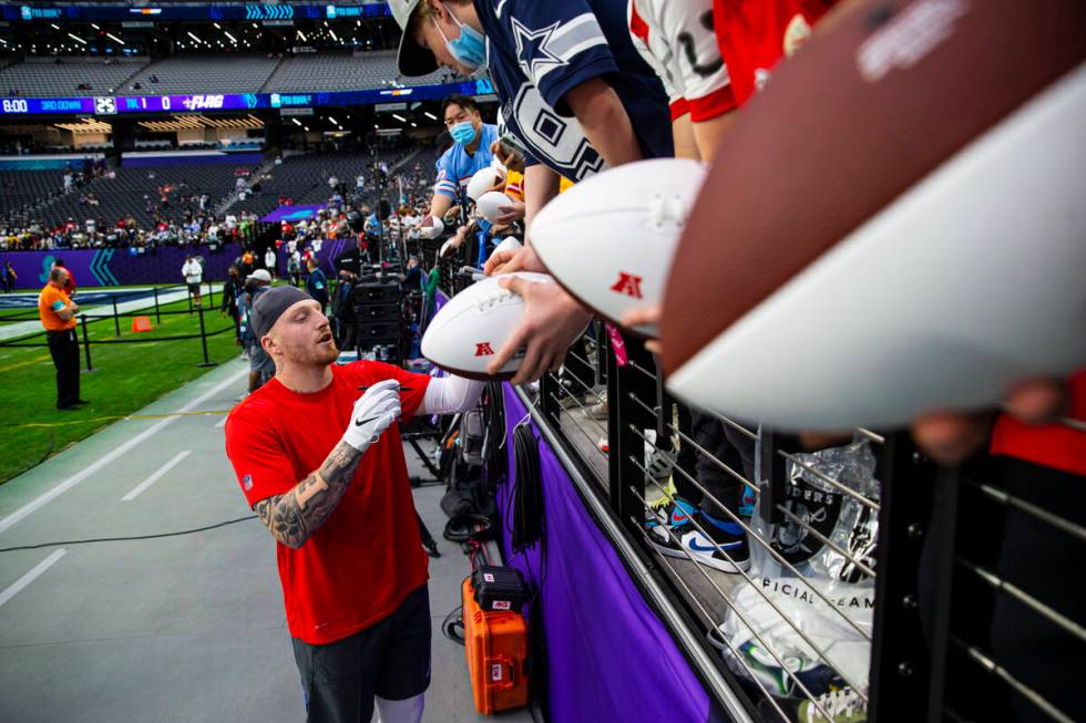 AFC defensive end Maxx Crosby of the Las Vegas Raiders autographs items for fans before the sta ...