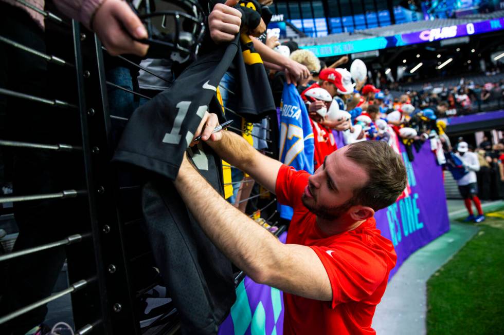 AFC wide receiver Hunter Renfrow of the Las Vegas Raiders autographs items for fans before the ...