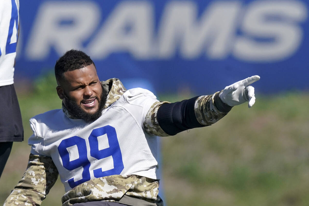 Los Angeles Rams defensive end Aaron Donald gesture prior to practice for an NFL Super Bowl foo ...