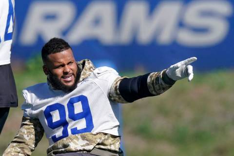 Los Angeles Rams defensive end Aaron Donald gesture prior to practice for an NFL Super Bowl foo ...