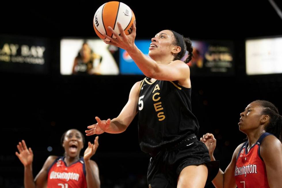 Las Vegas Aces forward Dearica Hamby (5) drives past Washington Mystics center Tina Charles (31 ...