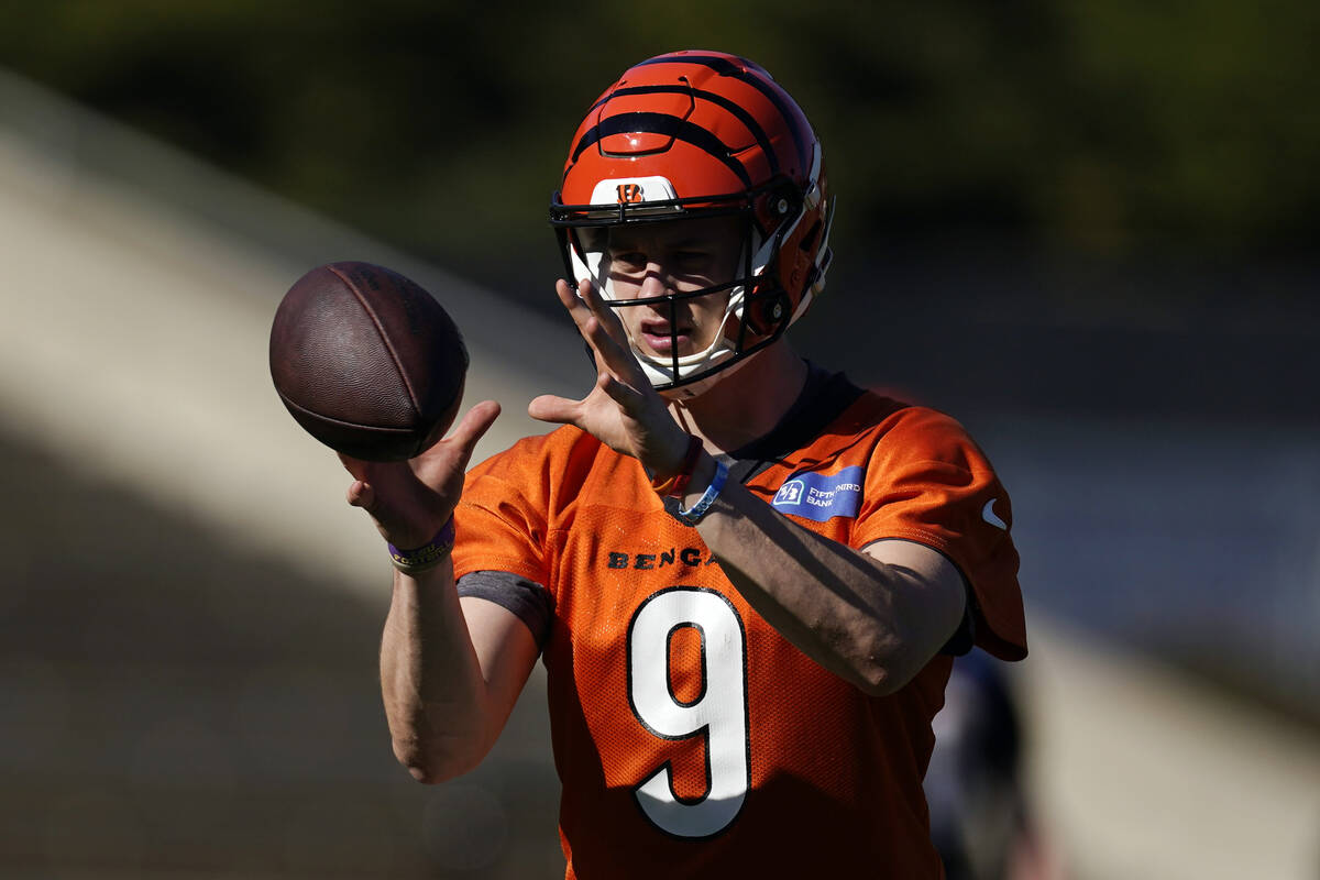 Cincinnati Bengals quarterback Joe Burrow (9) takes a snap during NFL football practice Wednesd ...