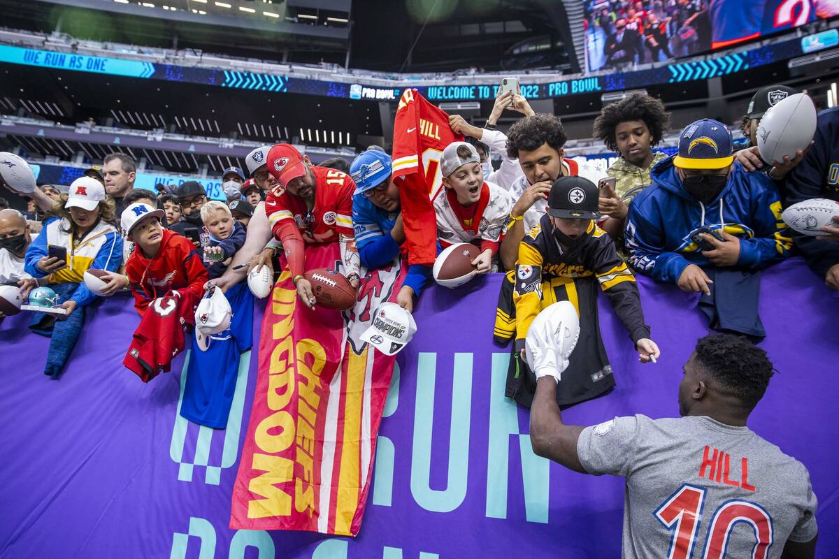 AFC wide receiver Tyreek Hill of the Kansas City Chiefs (10) signs autographs for fans during w ...