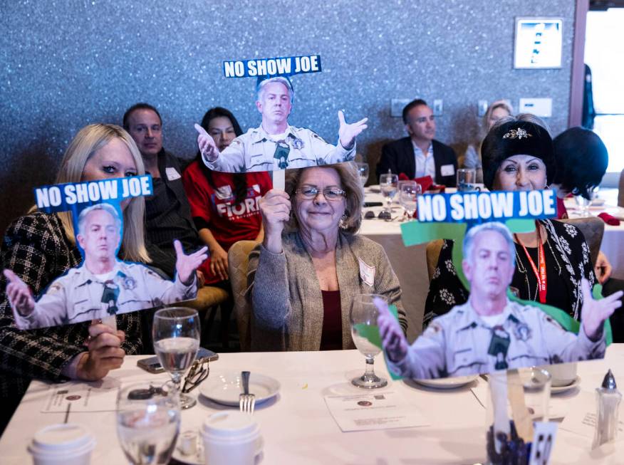 Pam Bennets, left, and Judy Leslie, center, hold cutouts of Nevada Republican governor candidat ...