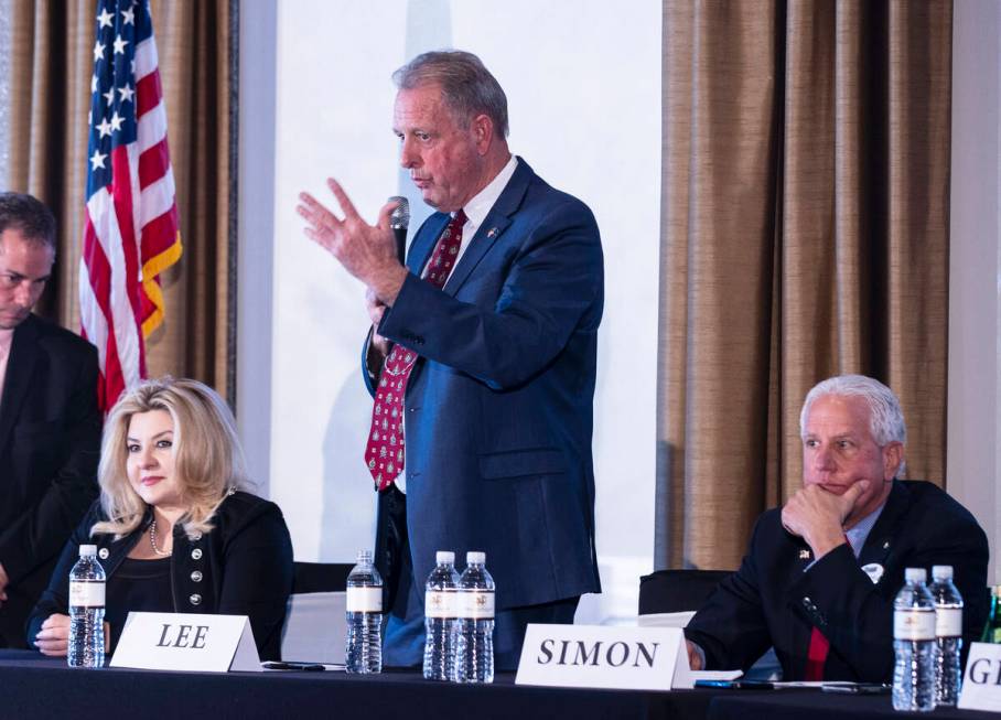 Nevada Republican governor candidates Michele Fiore, left, and Fred Simon, listen as North Las ...