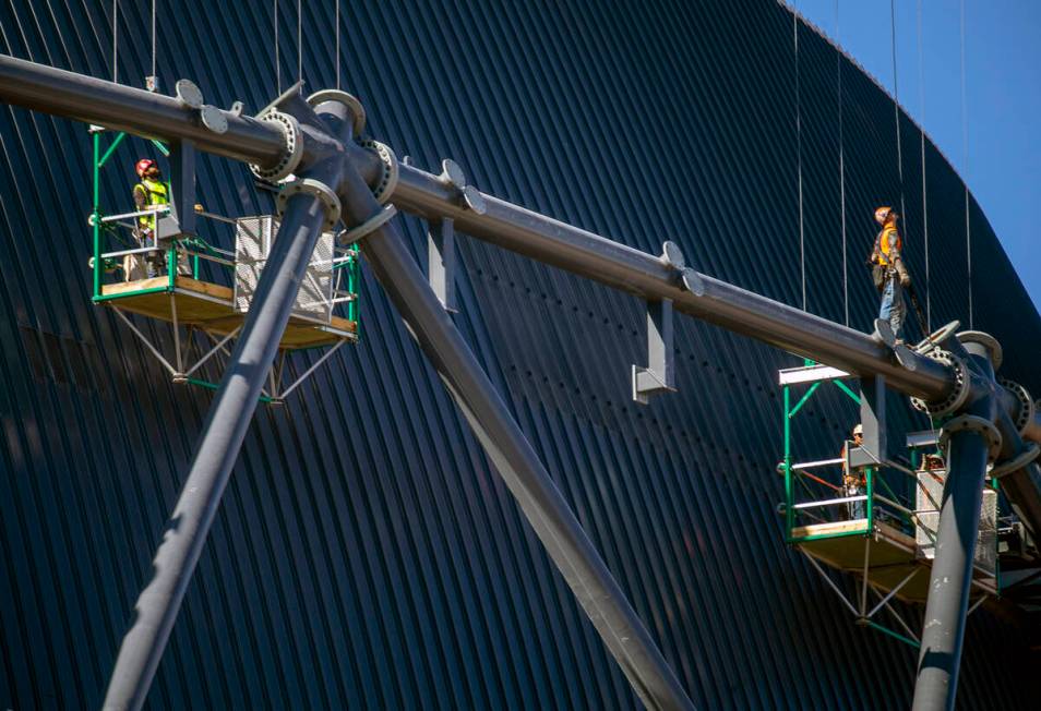 A construction crew looks up as more steel is being lifted to them at the MSG Sphere at The Ven ...