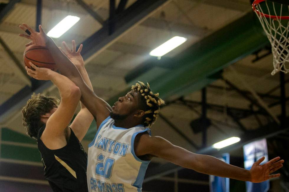 Canyon Springs forward Lorenzo Moore (20) blocks a shot attempted by Spring Valley forward Cars ...