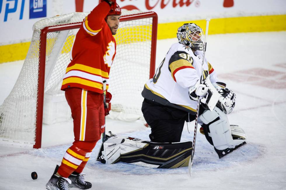 Vegas Golden Knights goalie Robin Lehner, right, looks away as Calgary Flames' Milan Lucic cele ...