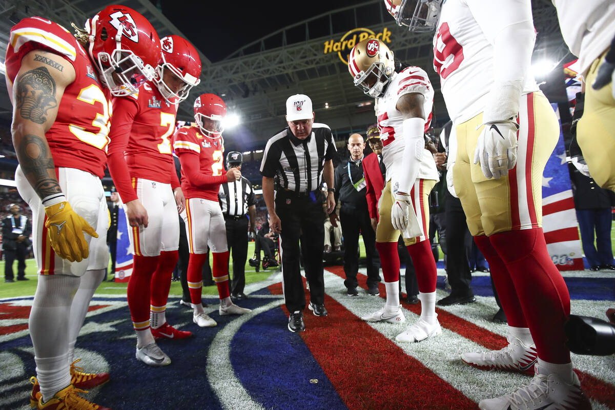 Referee Bill Vinovich (52) flips the coin during the coin toss ceremony before the NFL Super Bo ...