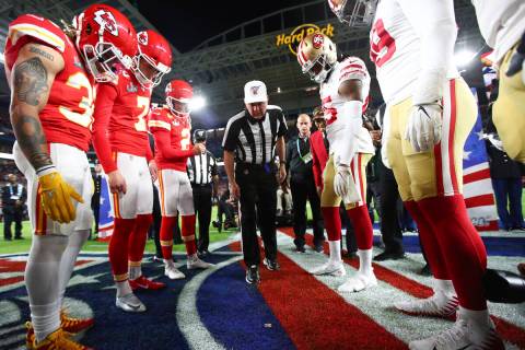 Referee Bill Vinovich (52) flips the coin during the coin toss ceremony before the NFL Super Bo ...