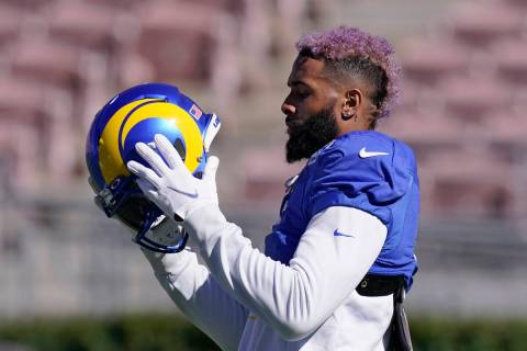 Los Angeles Rams wide receiver Odell Beckham Jr. puts on his helmet during practice for an NFL ...