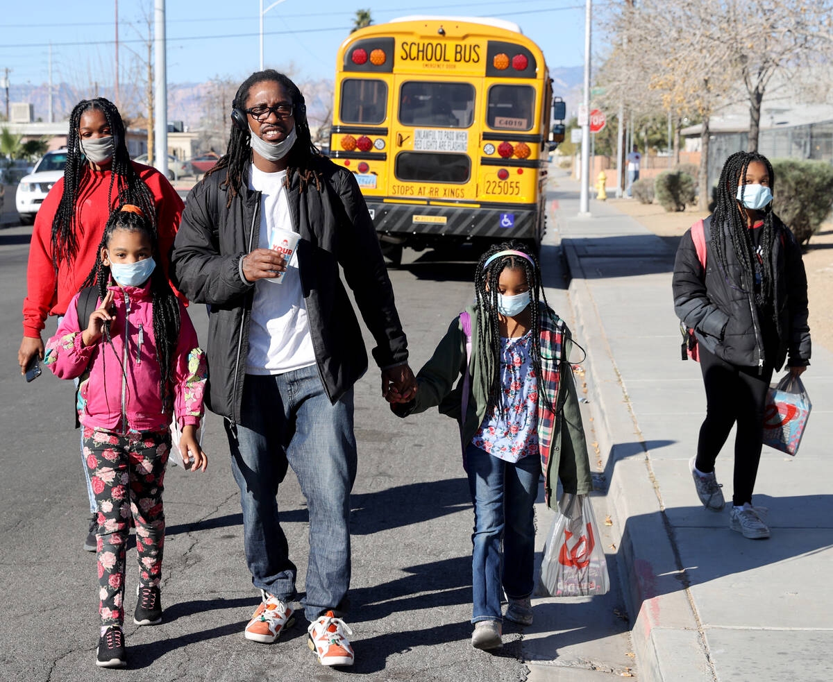 Kendrick Belford and his wife Daneah drop off their daughters, from left, Jay’moni, 8, N ...