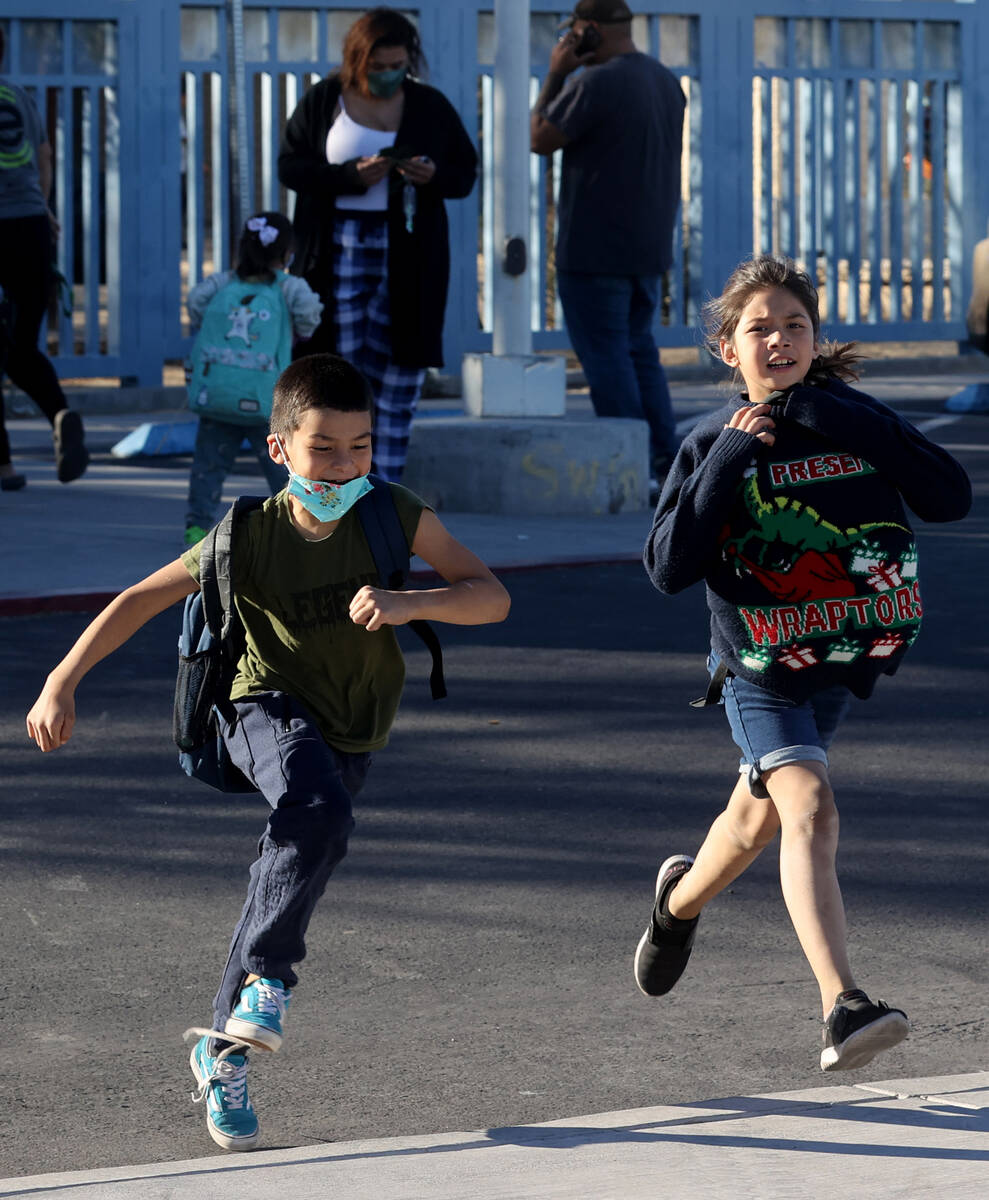 Javier Alvarez, 6, races his sister Allyson, 7, during dismissal at Beckley Elementary School i ...