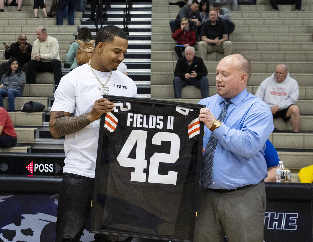 Daniel Wise, right, assistant principal of athletics, presents #42 Browns jersey to Cleveland B ...