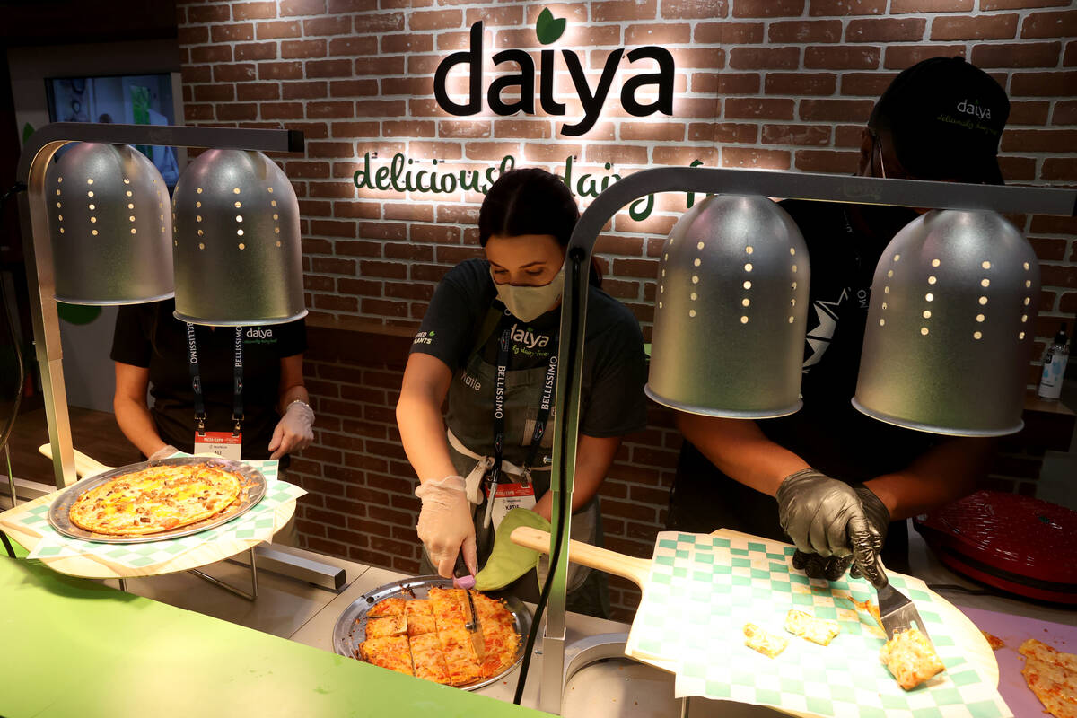 Katie Benford of Daiya Foods from Vancouver, Canada prepares samples of dairy free pizza during ...