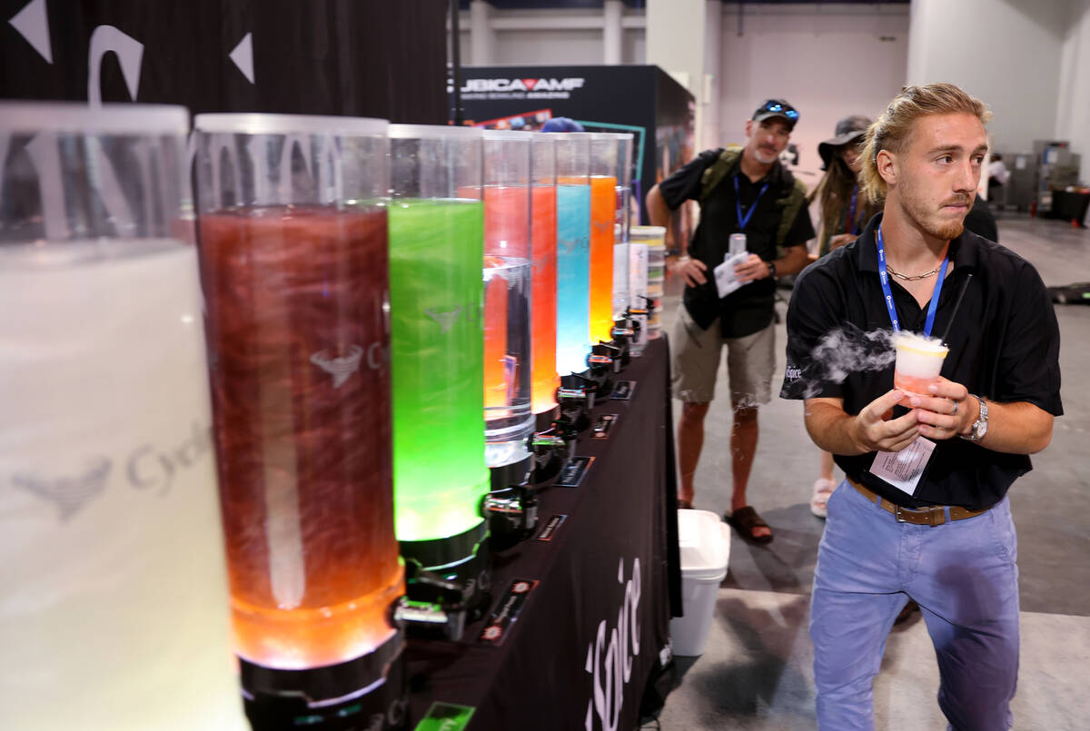 Jacob Radow of Reno prepares a drink sample using dry ice in the Roxi Spice booth Nightclub &am ...
