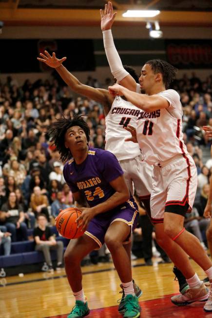 Durango High School's Taj Degourville (24) looks to pass against Coronado High School's Ron Jon ...