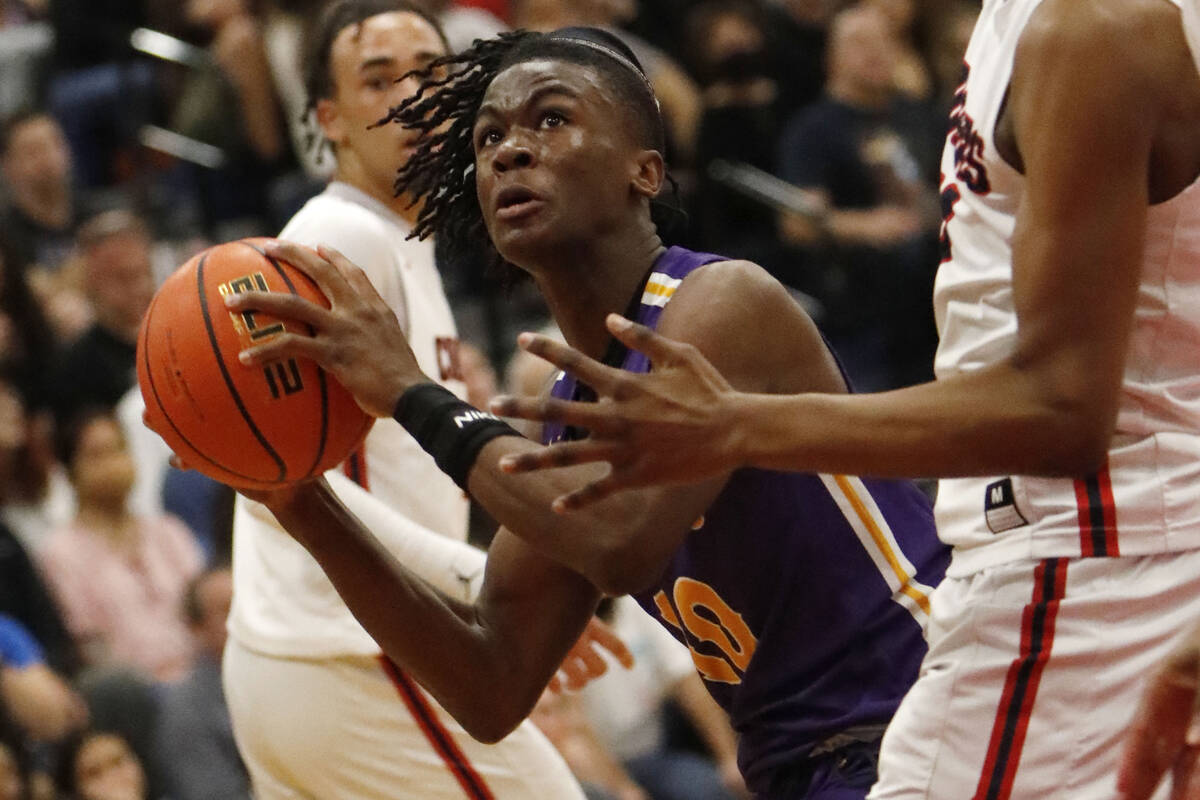 Durango High School's Tylen Riley, (10), center, goes to the basket against Coronado High Scho ...