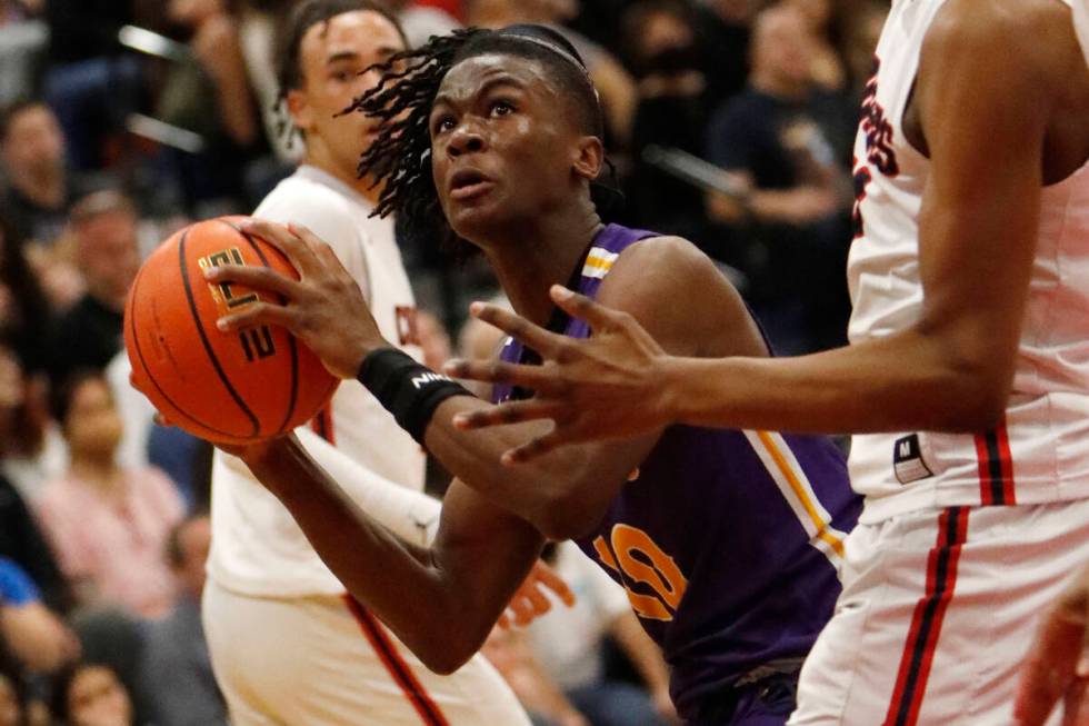 Durango High School's Tylen Riley, (10), center, goes to the basket against Coronado High Scho ...