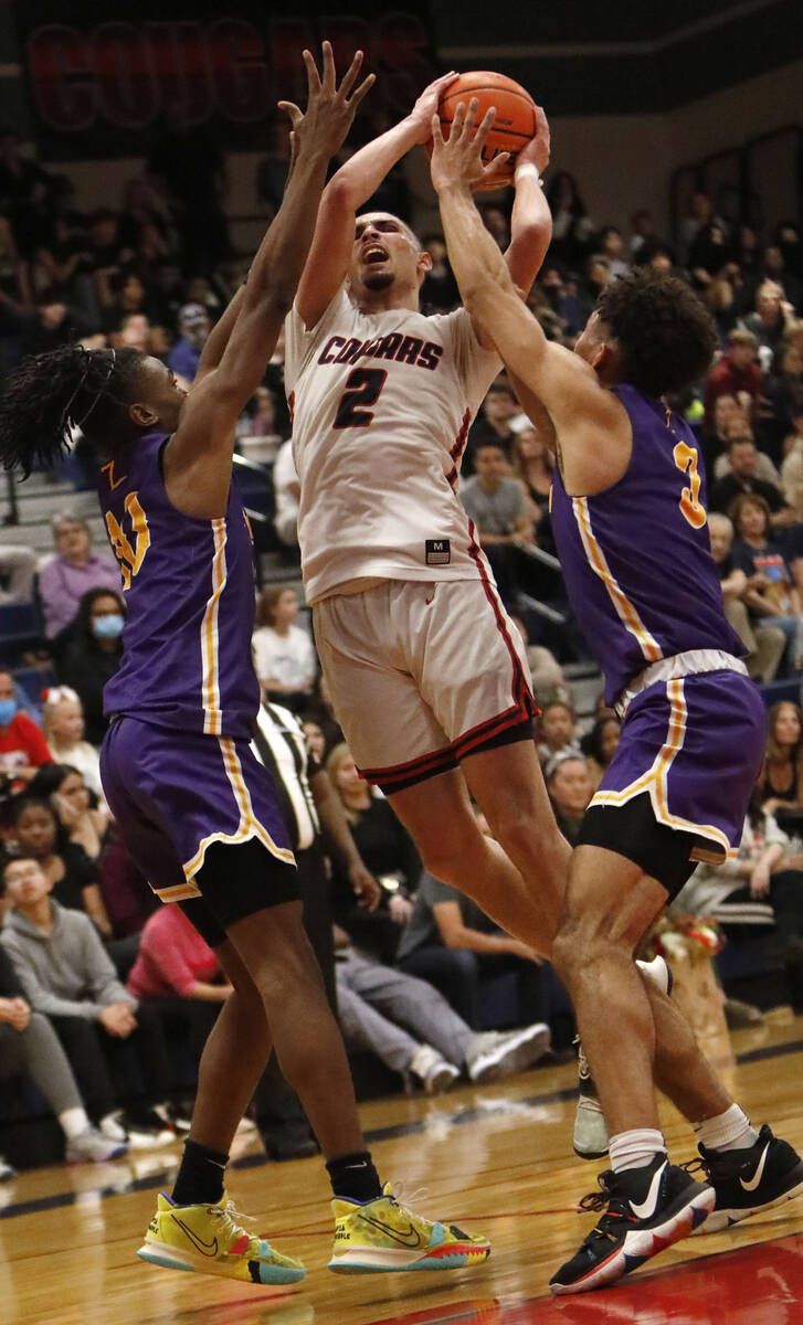 Coronado High School's Richard "Pop Pop" Isaacs (2) tries to shoot over Durango High ...