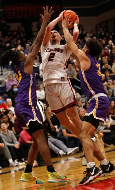 Coronado High School's Richard "Pop Pop" Isaacs (2) tries to shoot over Durango High ...