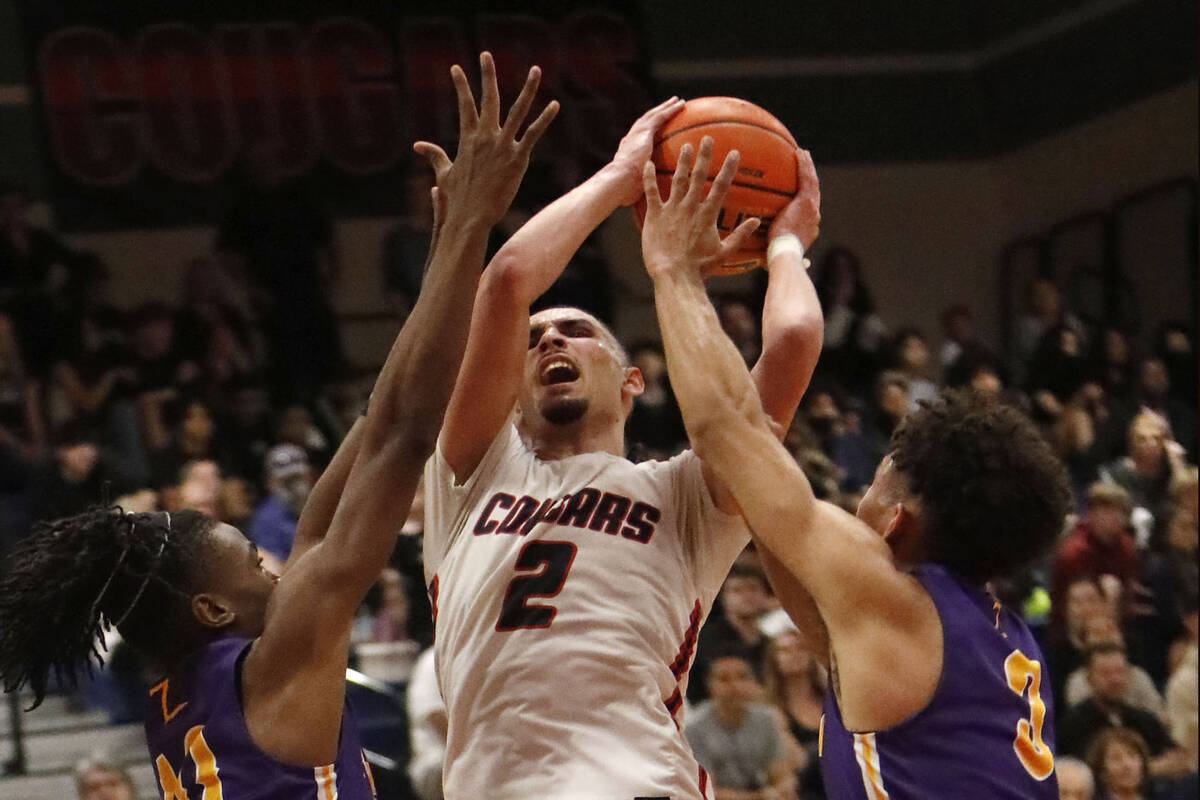 Coronado High School's Richard "Pop Pop" Isaacs (2) tries to shoot over Durango High ...