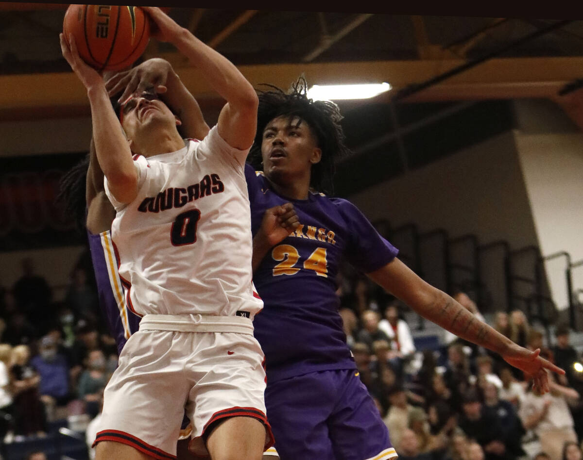 Coronado High School's Peralta (0) is fouled by Durango High School's Taj Degourville (24) duri ...