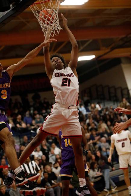 Coronado High School's Kodey Weary (21) shoots against Durango High School players during the s ...