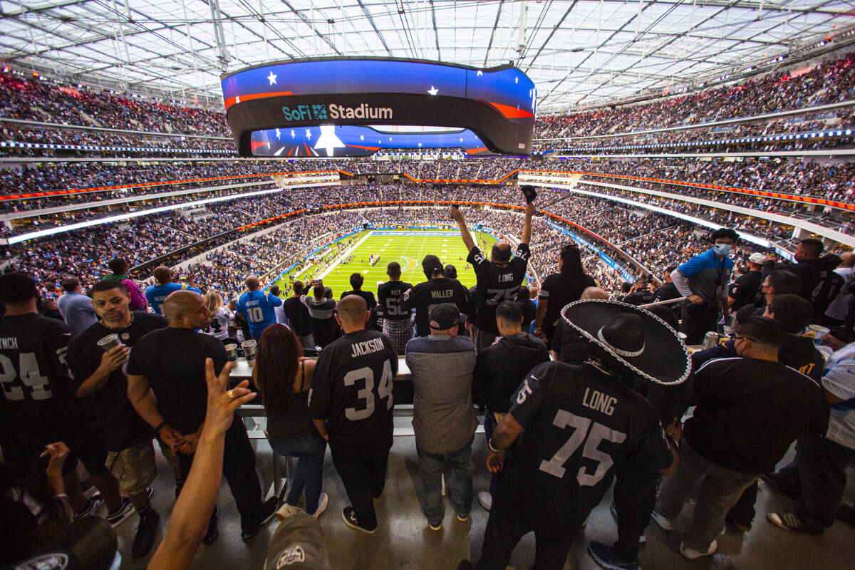 Raiders cheer at the end of the national anthem before the first half of an NFL game against th ...