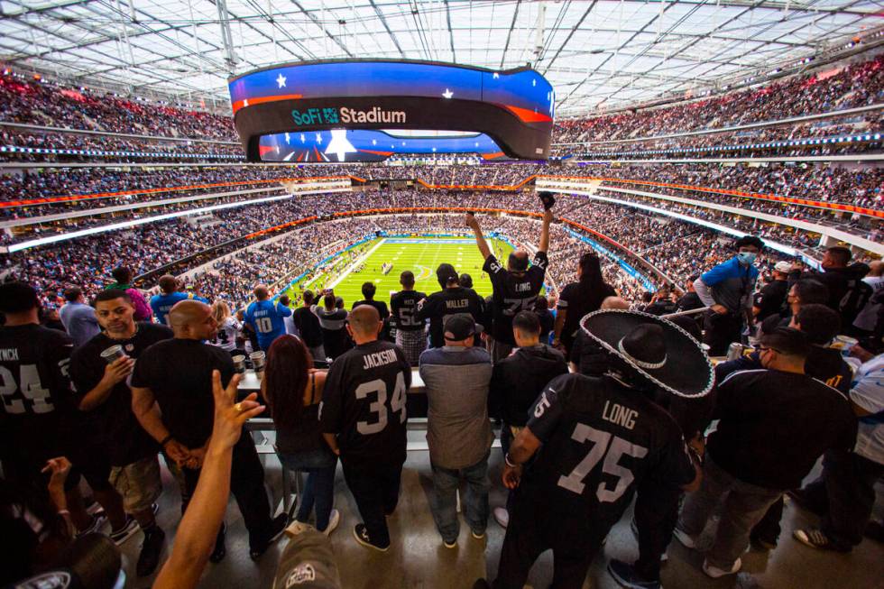 Raiders cheer at the end of the national anthem before the first half of an NFL game against th ...