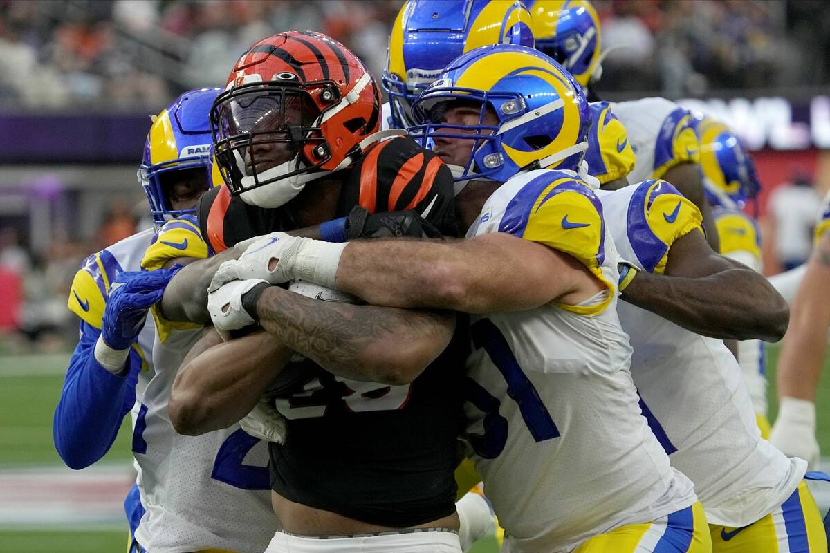 Cincinnati Bengals running back Joe Mixon, middle, is stopped by the Los Angeles Rams defense d ...