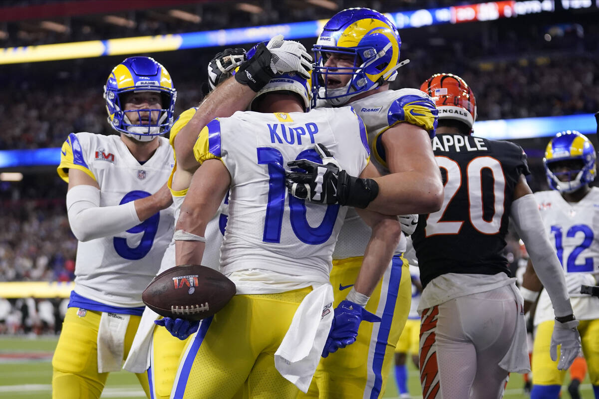 Los Angeles Rams wide receiver Cooper Kupp (10) is congratulated by teammates after scoring a t ...