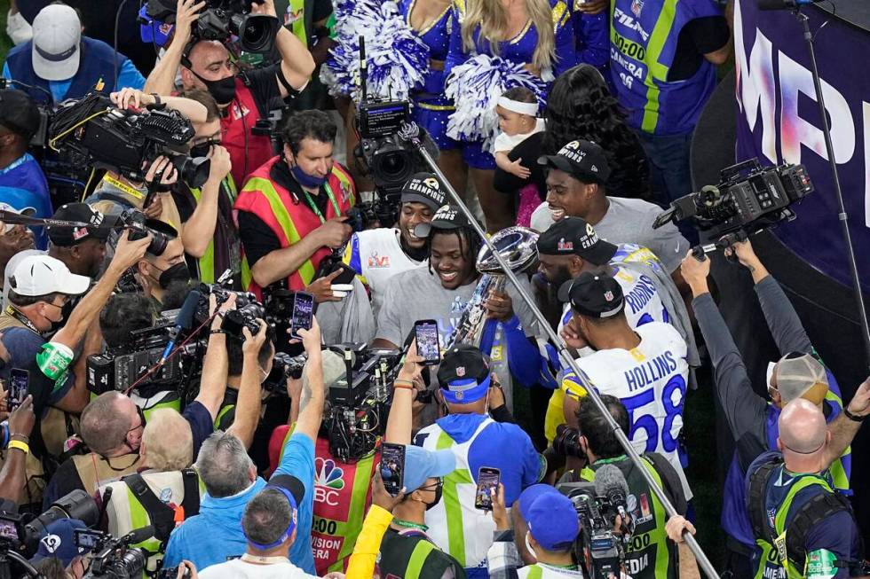 Los Angeles Rams players hold the Vince Lombardi trophy after the team won the NFL Super Bowl 5 ...