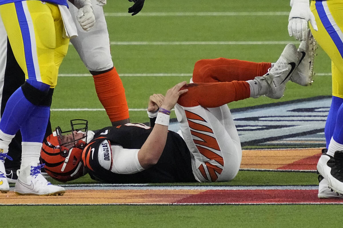 Cincinnati Bengals quarterback Joe Burrow (9) lies on the turf after being sacked during the se ...