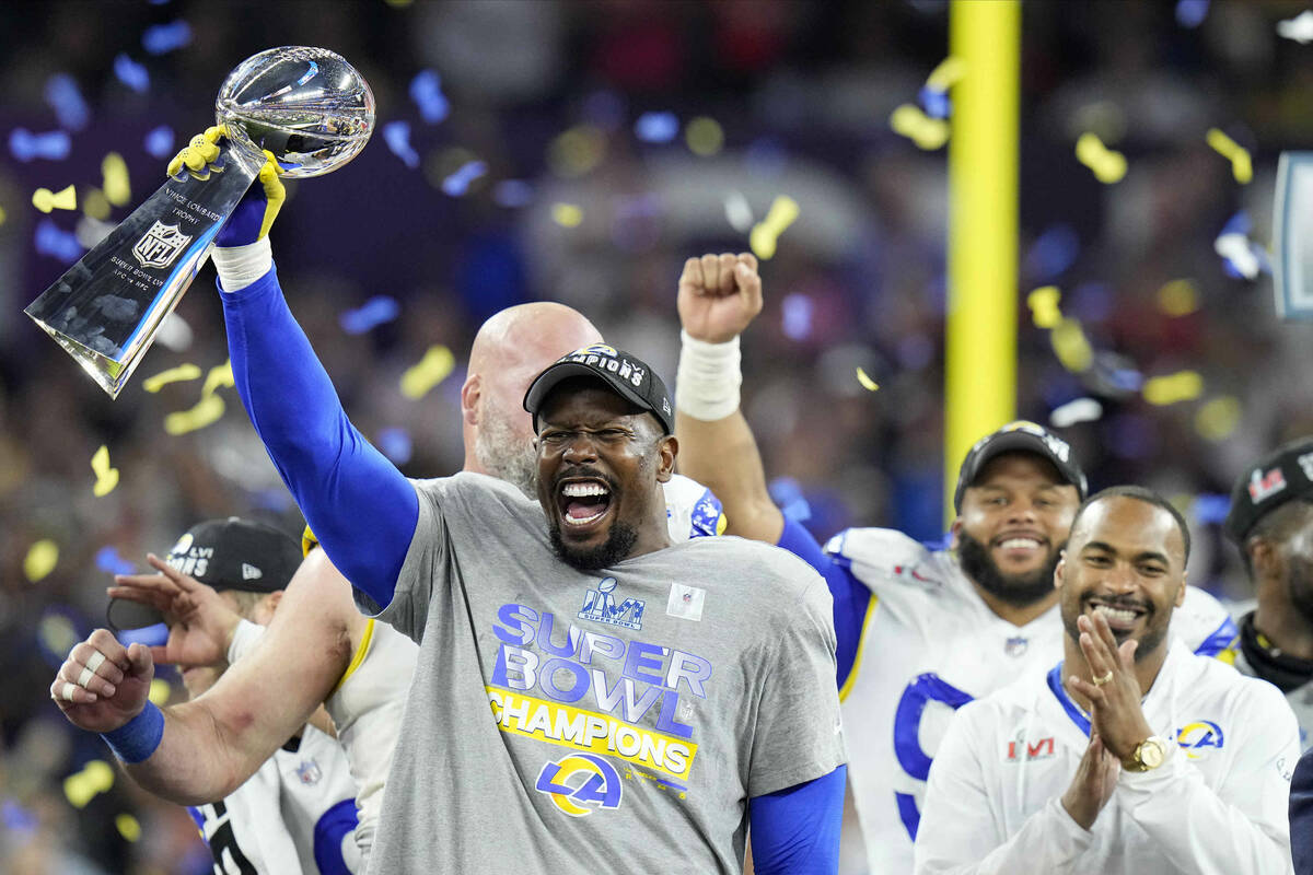 Los Angeles Rams outside linebacker Von Miller lifts the the Lombardi Trophy after the Rams def ...