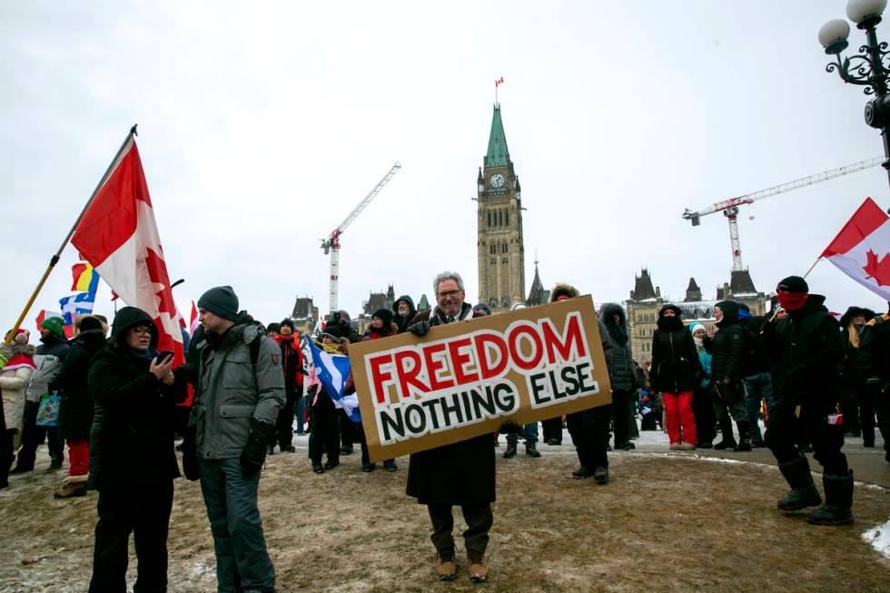 Don Stephens, 65, a retired graphic designer, holds a sign on Parliament Hill to support trucks ...