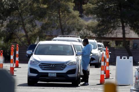 Cars line up for COVID-19 testing at the YMCA on Meadows Lane in Las Vegas Monday, Jan. 10, 202 ...