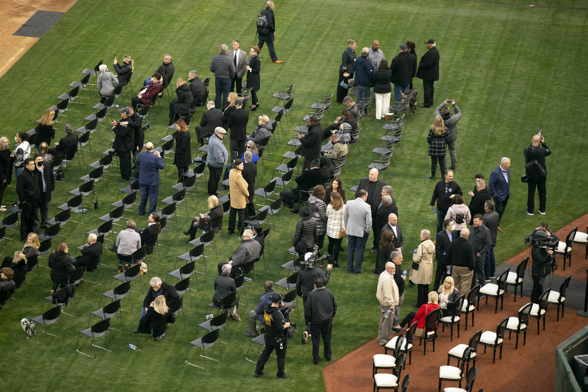 Guests gather on the field of the Oakland-Alameda County Coliseum before a memorial service for ...