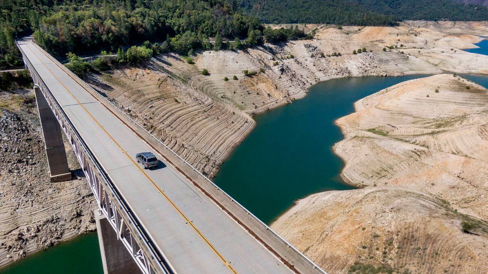 A car crosses Enterprise Bridge over Lake Oroville's dry banks on May 23, 2021, in Oroville, Ca ...