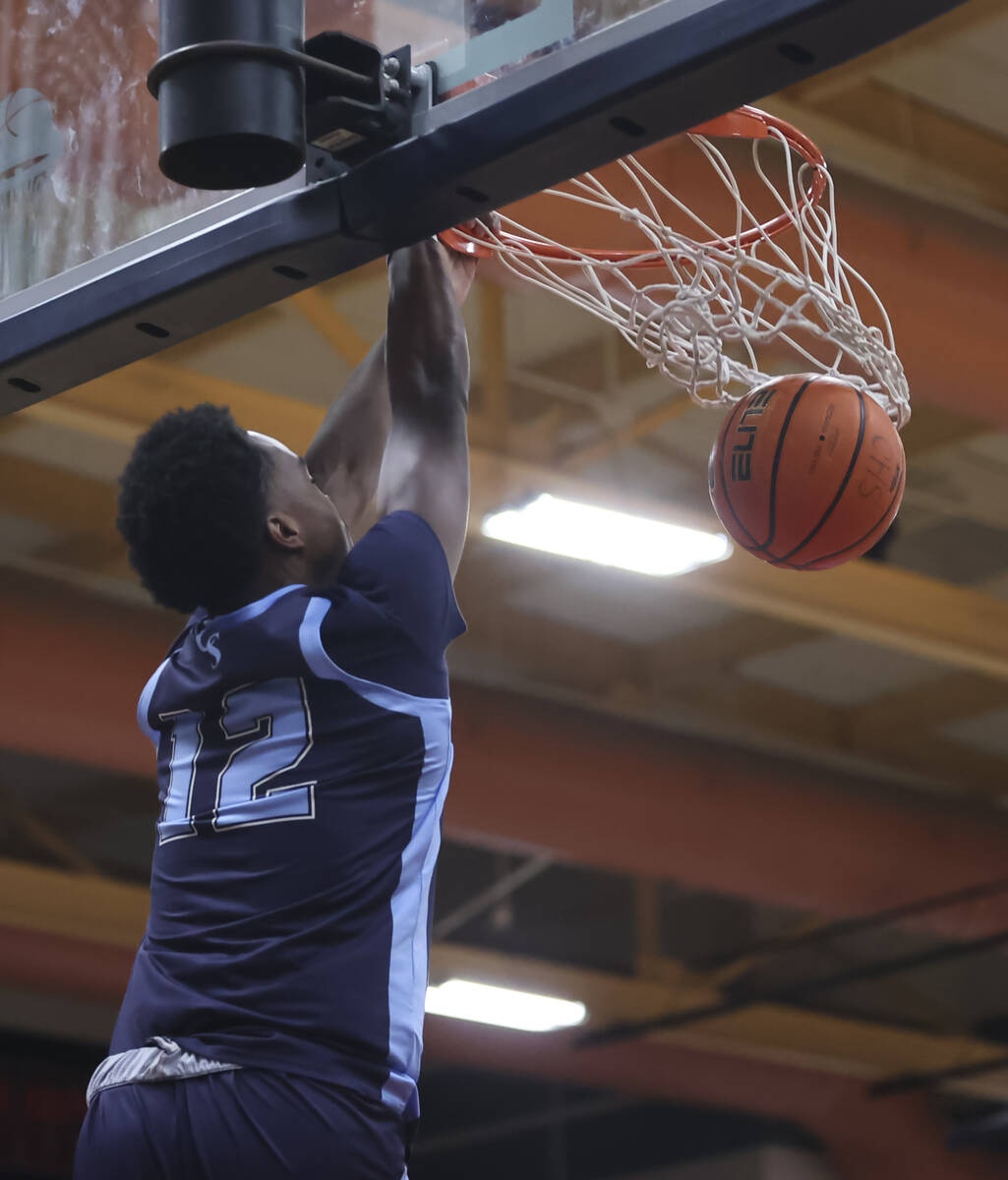 Canyon Springs' Jaylen Pollard (12) dunks the ball during the second half of a basketball game ...