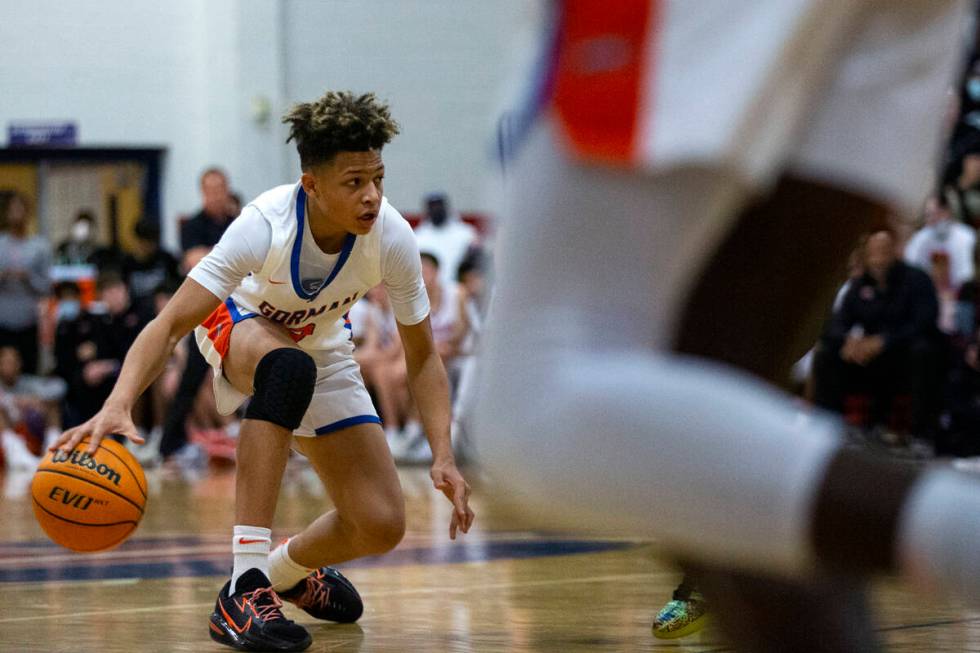 Bishop Gorman’s John Mobley Jr. (3) looks to pass during the first half of a boys high s ...