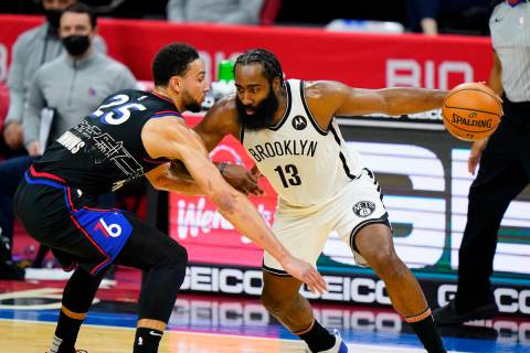 FILE - Brooklyn Nets' James Harden (13) tries to drive past Philadelphia 76ers' Ben Simmons (25 ...