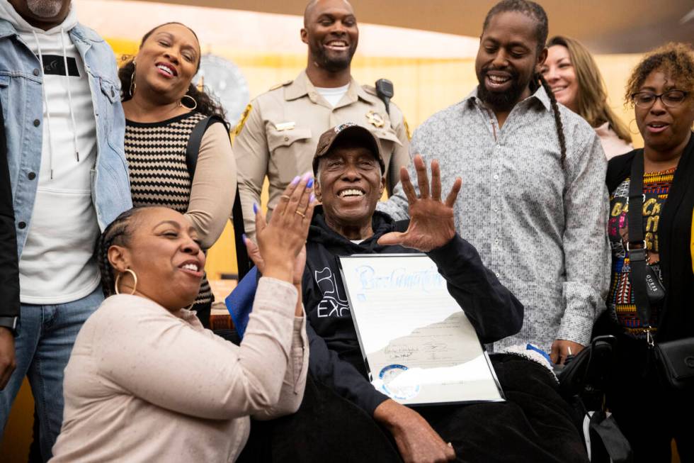 Retired Las Vegas police officer Herman Moody, 97, center, surrounded by family, clockwise from ...