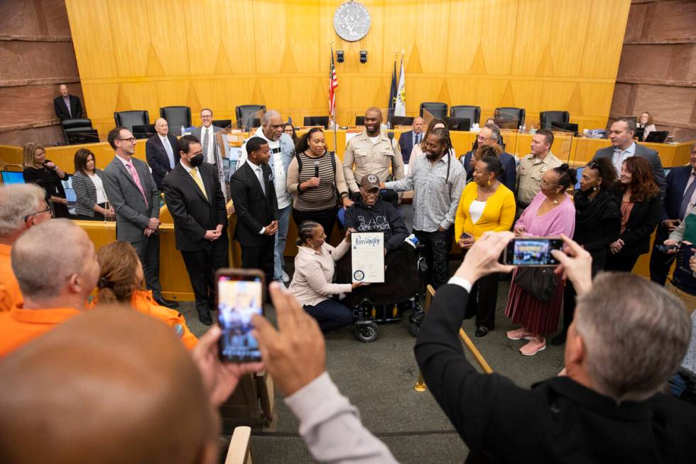 Retired Las Vegas police officer Herman Moody, 97, center, surrounded by family is recognized f ...