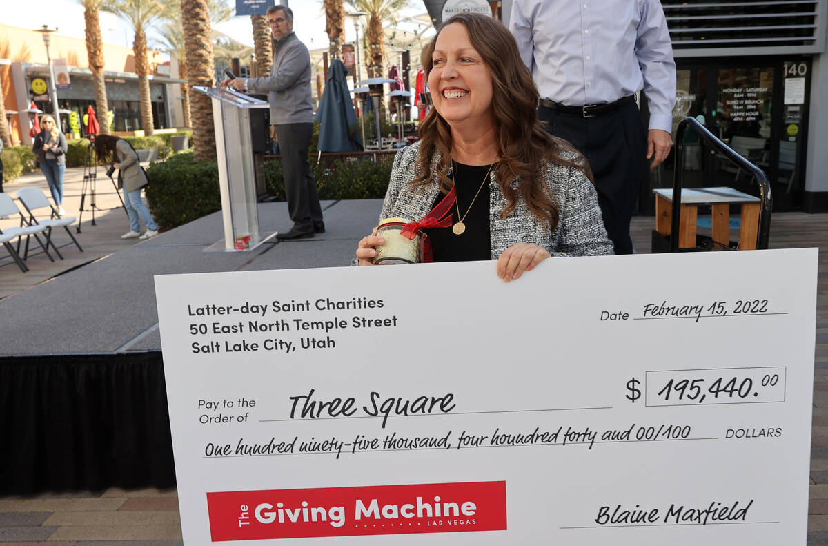 Michelle Beck with Three Square walks off the stage after receiving a check during a ceremony t ...