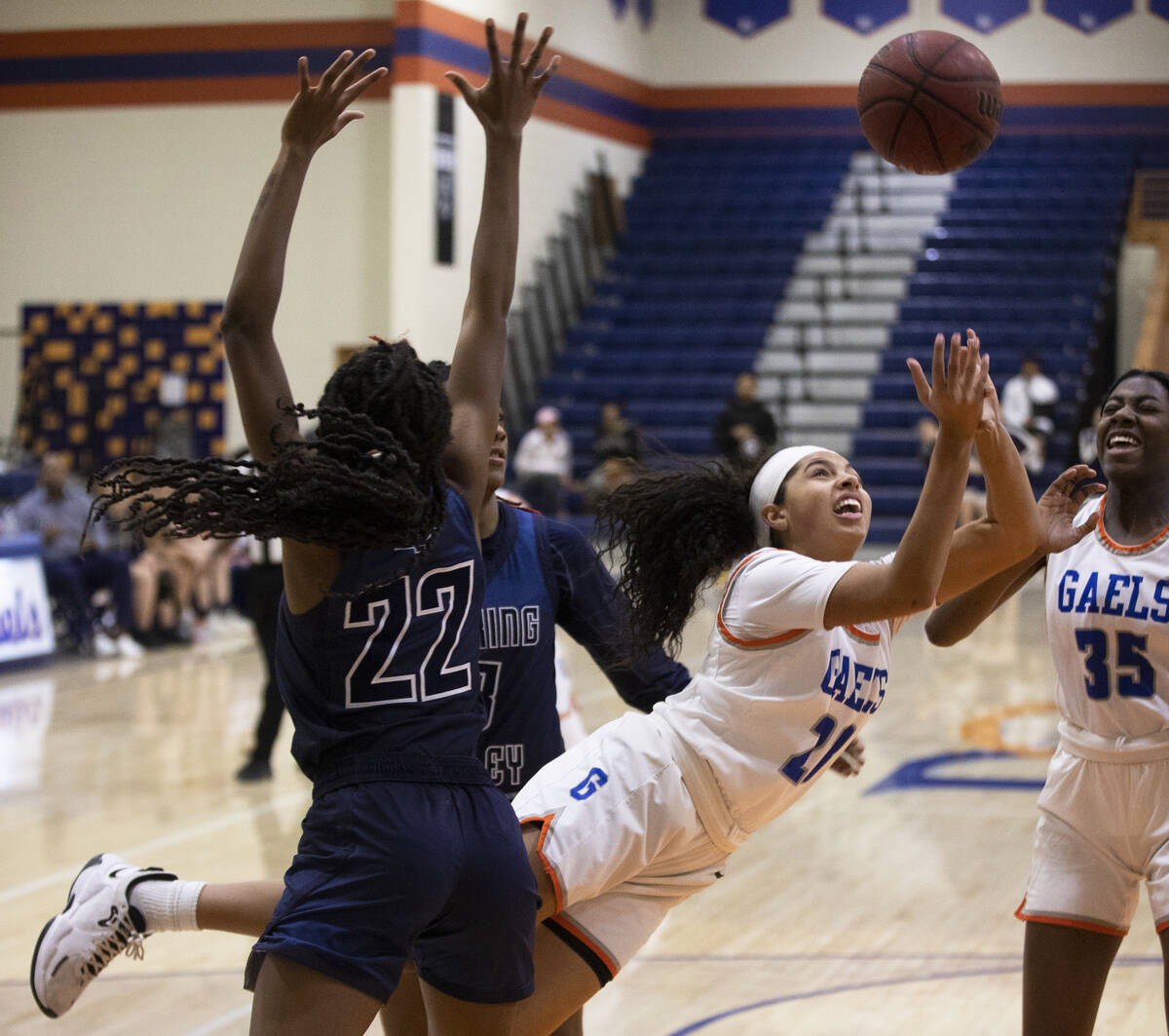 Bishop Gorman center Luci Purdy (21) draws a foul from Spring Valley forward Rayne Dunn (22) on ...