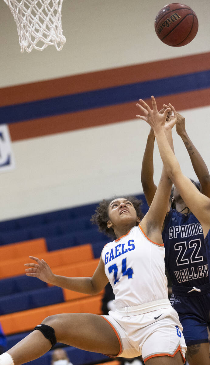 Bishop Gorman forward Shaolin Cooper (24) fights for a rebound with Spring Valley forward Rayne ...